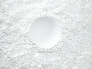 White flour texture background. Abstract powder texture. White powder surface with cracks and a round crater.