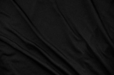 Dalgalı siyah kumaş dokusu arka planı. Kumaş kırışmış..