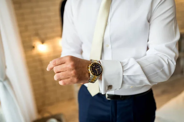 Wedding groom prepairing watches. Luxury business preparation.