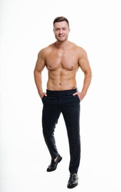 Shirtless sporty young man at isolated white background. Handsome athletic guy with strong chest.