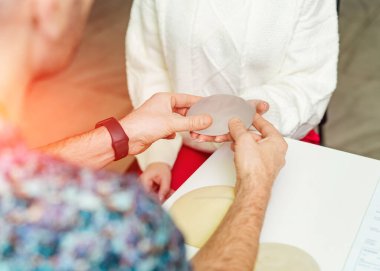 Medical operational breast correction. Silicone plastic surgery measuring implant.