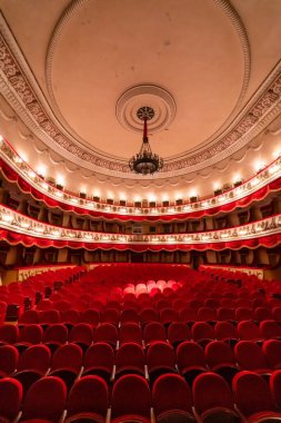 View of an empty theatre with red seats and balcony. Theater. Interior view