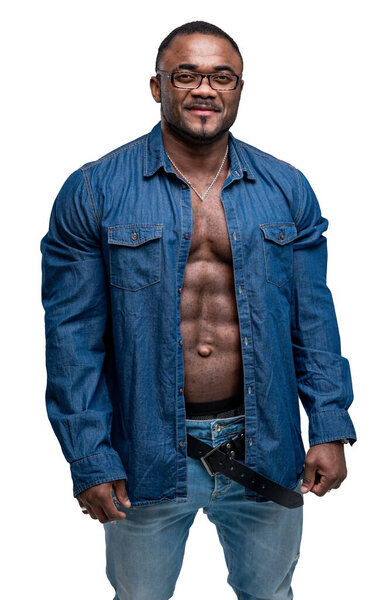 African man wearing jeans and unbuttoned shirt. Good abs of a dark-skinned man. Muscular man in the white background.