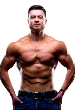 Beautiful young man with perfect body posing on white background. Strong hands on waist. Studio photoshoot.