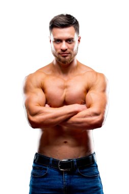 Portrait of a handsome guy with crossed hands over chest on a white background. Strong body and cool face. Studio Photoshoot. Closeup.
