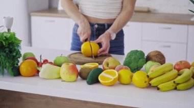 Mutfakta meyve kesen bir kadın. Güzel genç bayan mutfakta meyve salatası hazırlıyor.