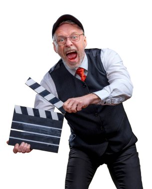 Senior handsome man holding a cinema clapper on a white background. Man wearing suit with no jacket. Man with movie flap while filming