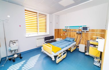 Recovery room with medical comfortable bed. Empty hospital modern bedroom.