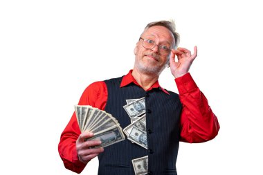Portrait of happy senior old business man with a smile holding money in hands, dressed in red shirt, isolated on white background. Human emotions and facial expressions