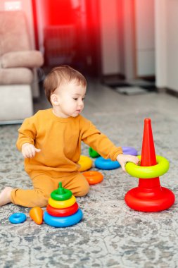 Adorable cute kid having activity. Little boy playing with certains.