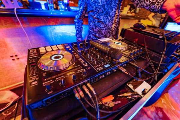 stock image A professional DJ setup with a wide range of equipment in a well-lit room. A dj set up in a room with a lot of equipment
