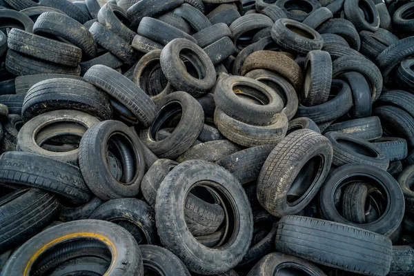 Used tires at recycling garbage field. Old tires trash storage.
