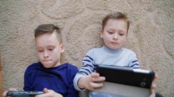 Boys Using Mobile Gadgets Home Close View Two Brothers Playing — Stock Video