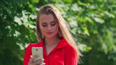 Cep telefonu kullanan gülümseyen kadın. Güzel stil sahibi kadın elinde cep telefonu tutuyor.