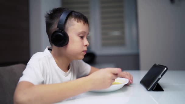 Cute Boy Looking Tablet While Eating Side View Little Boy — Stock Video