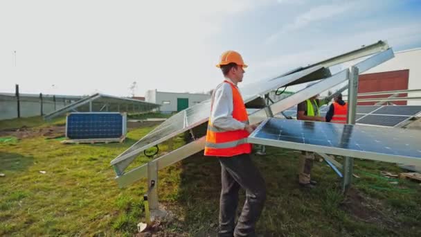 Trabalhadores Instalam Painel Solar Azul Base Metal Técnicos Uniforme Protetor — Vídeo de Stock