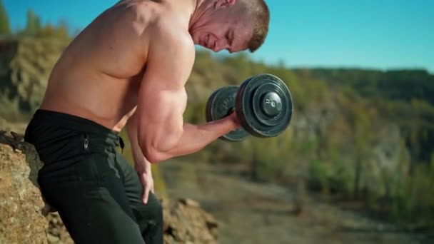 Sportsman Pumping Arm Muscles Rocky Background Shirtless Athletic Man Exercising — Stock Video