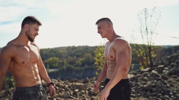 Two Sportsmen Greeting Each Other Nature Background Shirtless Bodybuilders Muscular — Stock Video