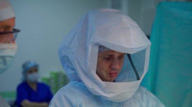 Ameliyathanede sağlık görevlileri var. Koruyucu mavi üniformalı bir grup doktor hastanede birlikte çalışıyorlar. Tıp konsepti.