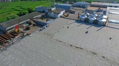 Çatıda bir inşaat var. Düz çatıda güneş çiftliği inşa etmek. Geleceğin alternatif elektrik santralinin inşaat alanındaki inşaatçılar binanın tepesinde. Hava görünümü.
