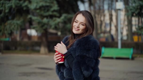 Positive Young Woman Park Attractive Girl Stylish Fur Coat Holds — Stock Video