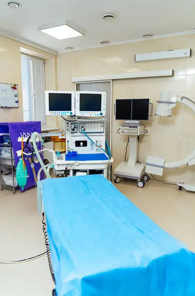 Modern clinic surgery room. Hospital operation interior with table and lamp.