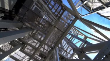 Bir fabrikanın çelik çerçeve inşaatı. Modern depo inşaatı. Metal merdiven yapıları yükseliyor. Sanayi fabrikası.