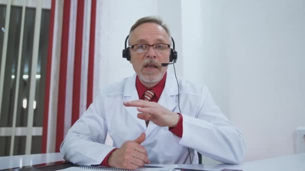 Portrait Doctor Glasses Headset Medical Specialist Sitting Hospital Office Talking — Stock Video