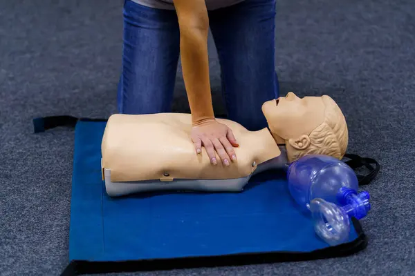 A dummy being placed on a blue mat. A Dummy on a Blue Mat, Symbolizing Practice, Training, and Preparation