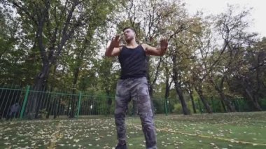 Genç adam dışarıda egzersiz yapıyor. Stadyumda atletizm antrenmanı