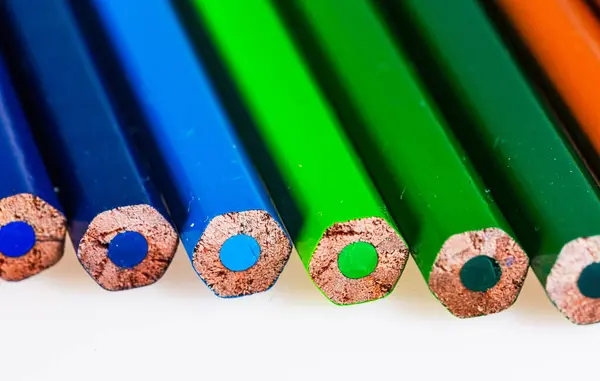 A group of colored pencils lined up in a row