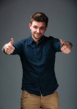 İki eliyle işaret veren bir adam. Çift Başparmak Yukarı: El Hareketleriyle Onay ve Olumlu Bir Adam Gösteriyor