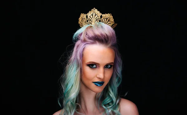 A woman with blue and green hair wearing a tiara. A Woman with Vibrant Blue and Green Hair Wearing a Sparkling Tiara