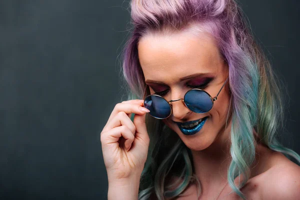 A woman with purple hair and blue glasses. A Vibrant Woman with Purple Hair and Blue Glasses Shining with Individuality