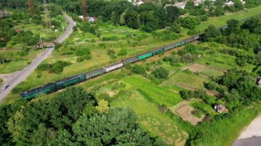 Kargo treninin hava görüntüsü. Demiryolunun üstünden yeşil ormanın içinden hava manzarası