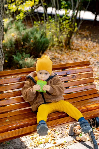 A Serene Moment. A Small Child Finding Solace on a Rustic Wooden Bench. A small child sitting on a wooden bench