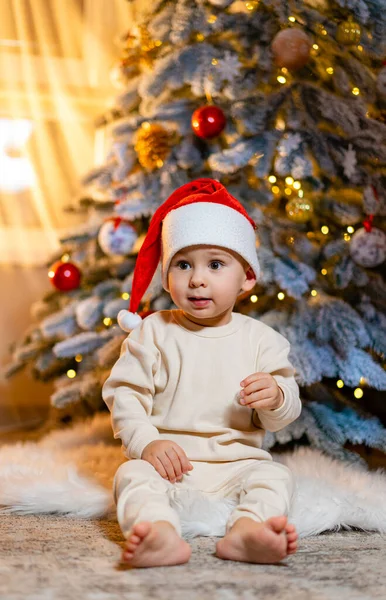 Baby Sitting Front Christmas Tree Baby Sitting Front Christmas Tree Stock Picture