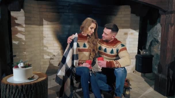 Beautiful Couple Sitting Fireplace Drinking Tea Man Tenderly Hugs Woman — Stock Video