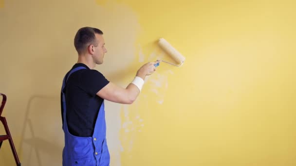 Młody Pracownik Maluje Ścianę Pokoju Koncepcja Naprawy Budowy Domu — Wideo stockowe