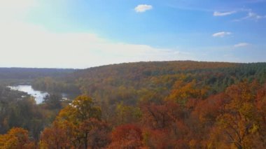 Gündoğumunda sonbahar ormanları, çayırlar ve tepelerin üzerinden uçacağız. Sonbahar ormanı ve sabah büyük nehir üzerinde yavaş bir uçuş. Kuşbakışı çekim..