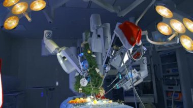 Üzerinde Noel süsleri ve etkileyici robot kolları olan bir ameliyat masası. Mandalina soyan ve köknar ağacı dekore eden Da Vinci sistemli bir ameliyathane. Arka planda özel ameliyat ekipmanları.