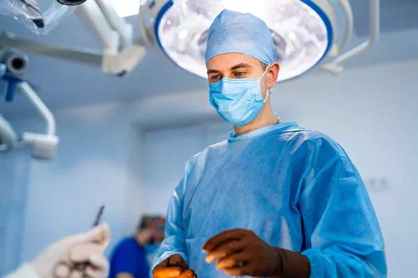 Professional surgeon working in emergency room. Healthcare surgical technologies.