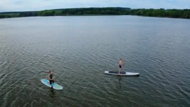 İki Kişi Kürek Çekiyor. Sup paddle tahtalarında çift görüntüsü