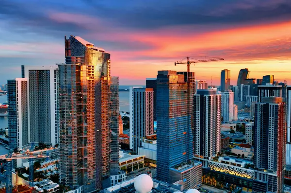 Aerial Sunset View of Tall Buildings in Miami, USA. Capture a breathtaking sunset view of the Miami skyline with its impressive tall buildings.