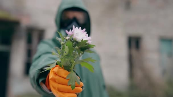 Environment Man Wearing Mask Breathing Protective Suit Holding Flower Ruined — Stock Video