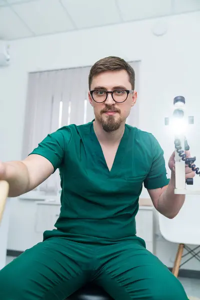 Handsome medical specialist portrait. Doctor in uniform working in hospital room.