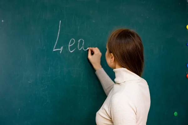 Woman Writing on Blackboard With Chalk - Teaching, Education, Classroom, Learning, Knowledge