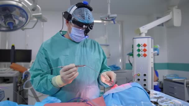 現代のクリニックでのナス手術 専門医は一般麻酔の下で患者に手術を行っています 医療機器による手術 — ストック動画