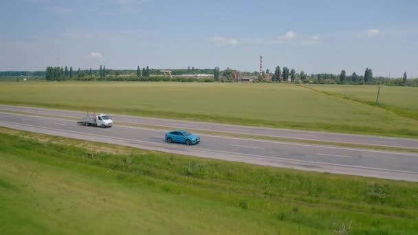 高速道路の近代的なブルーオーディオ 高級車が道路を走っている 美しいエコカーの発表 エアリアルビュー — ストック動画