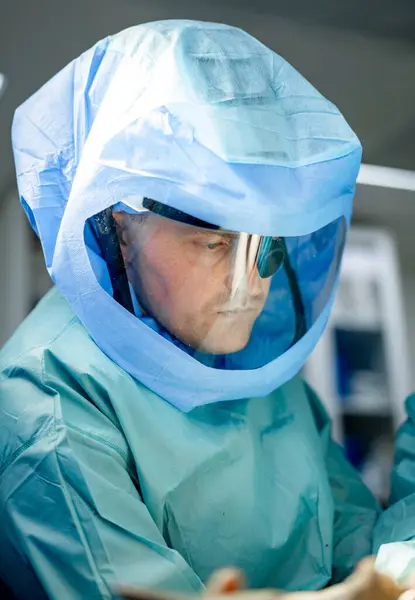 Professional medical man in uniform. Surgery sterile suit operating man portrait.